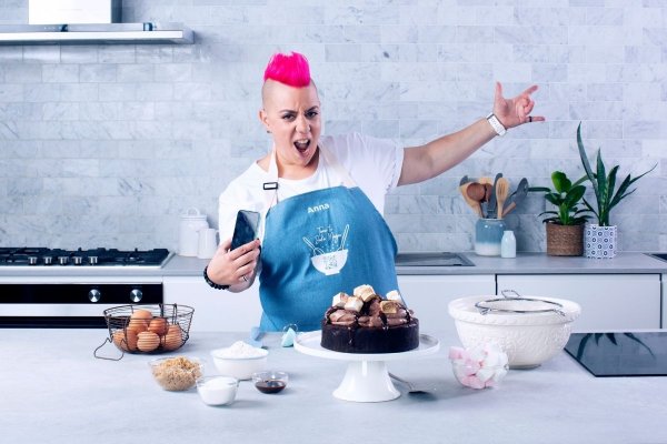 Anna Polyviou with her Hot Chocolate Cake in a kitchen.