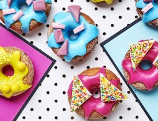 Pink, blue and yellow icing on doughnuts